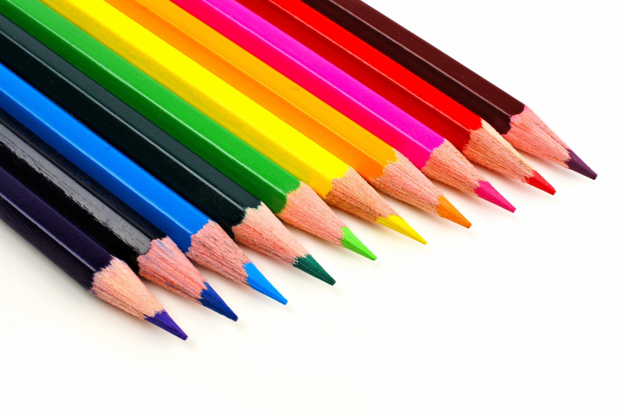 Row of colorful pencil crayons coming from corner 